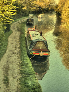 Textured effect portrait image of canal boats on the Trent and Mersey Canal near Swarkestone Lock, Derbyshire