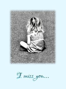 small girl sitting cross-legged on asphalt with back to camera and blue background. I miss you card